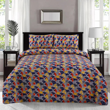 Colorful patterned bedspread on a bed in a bedroom setting with nightstands and decor.