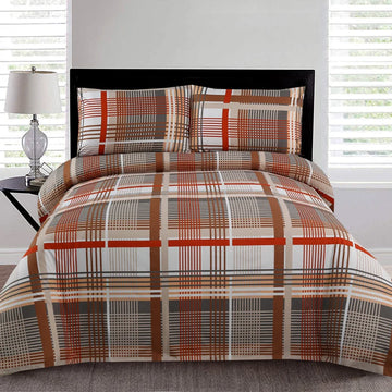 Plaid patterned bedspread on a bed with matching pillows in a bedroom setting.