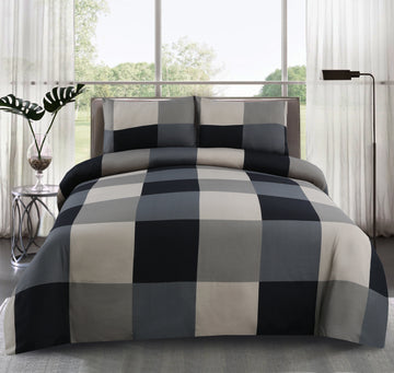 Checkered bedspread on a bed in a bright room with large windows.