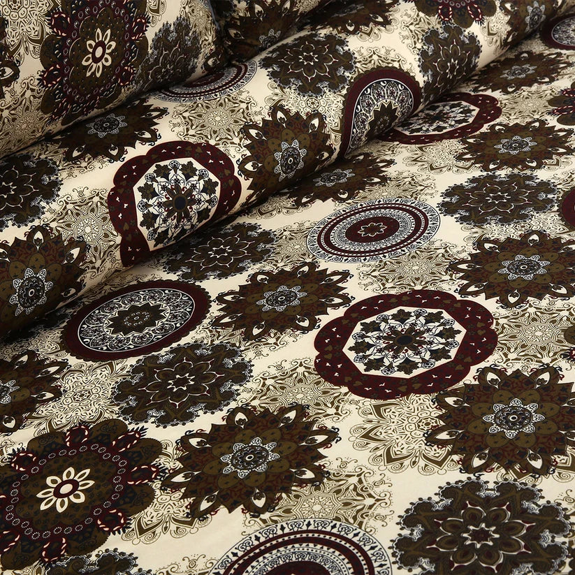 Close-up of patterned fabric with intricate designs on a beige background