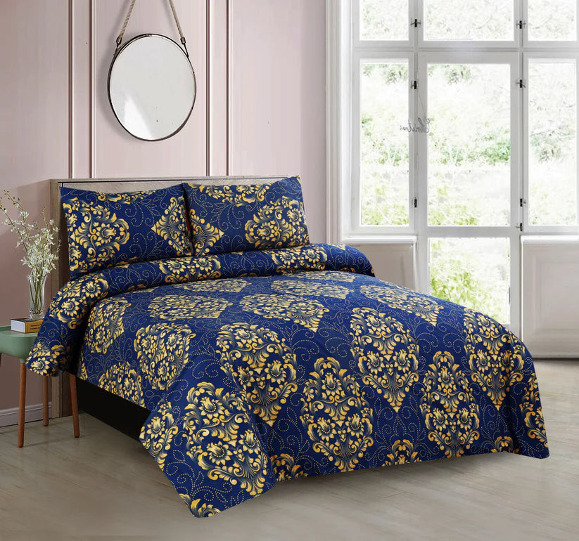 Blue and gold patterned bedding set on a bed in a bedroom with a window and mirror.