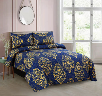 Blue and gold patterned bedding set on a bed in a bedroom with a window and mirror.