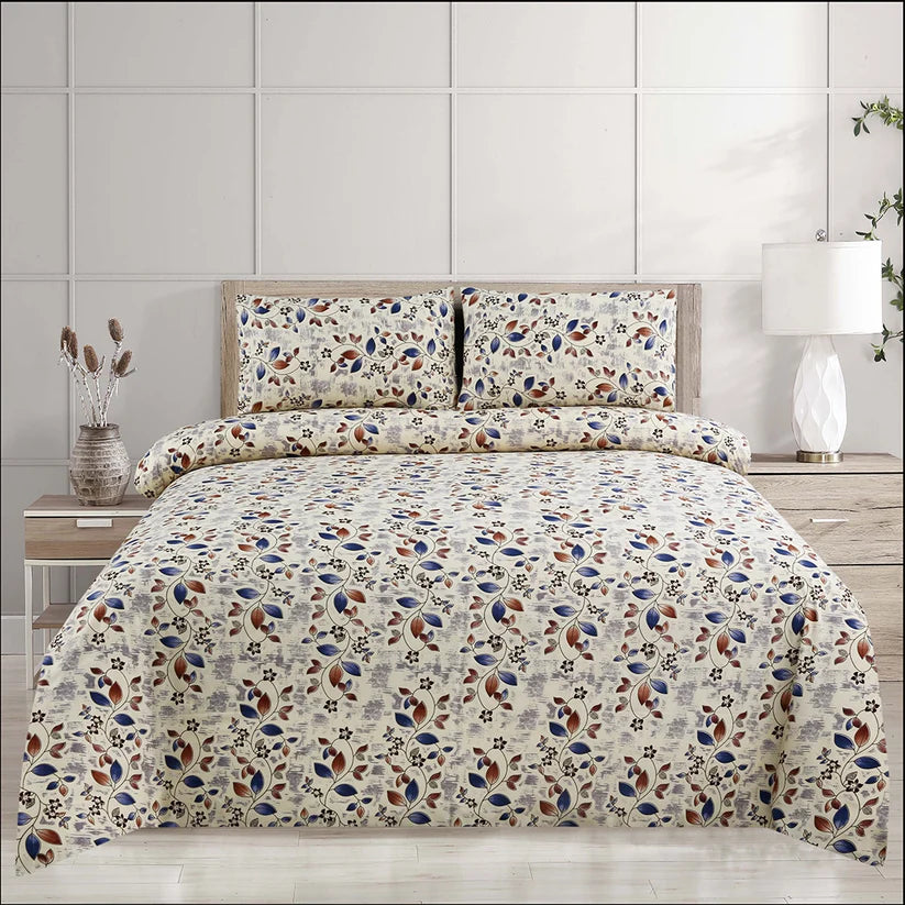 Floral patterned bedding set on a bed with matching pillows and a lamp in the background.