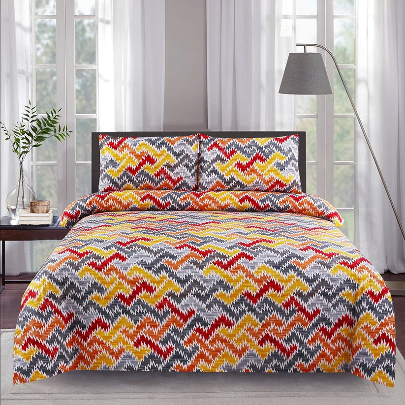 Bed with colorful zigzag pattern bedding set in a room with large windows.
