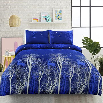 Blue and white tree-patterned comforter set on a bed with matching pillows, in a room setting.