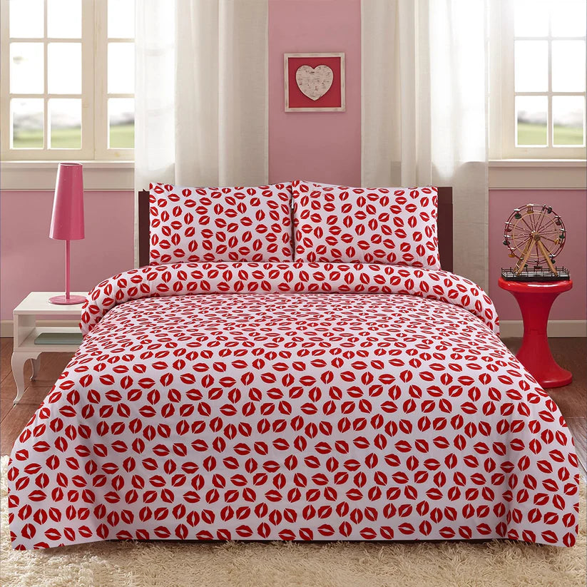 Bed with red and white patterned bedding in a room with pink walls and white curtains.