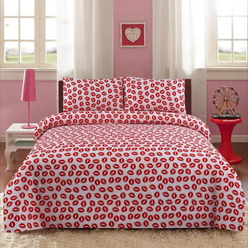 Bed with red and white patterned bedding in a room with pink walls and white curtains.