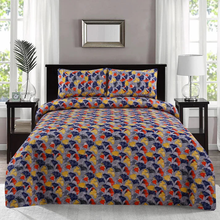 Colorful patterned bedspread on a bed in a bedroom setting with nightstands and decor.