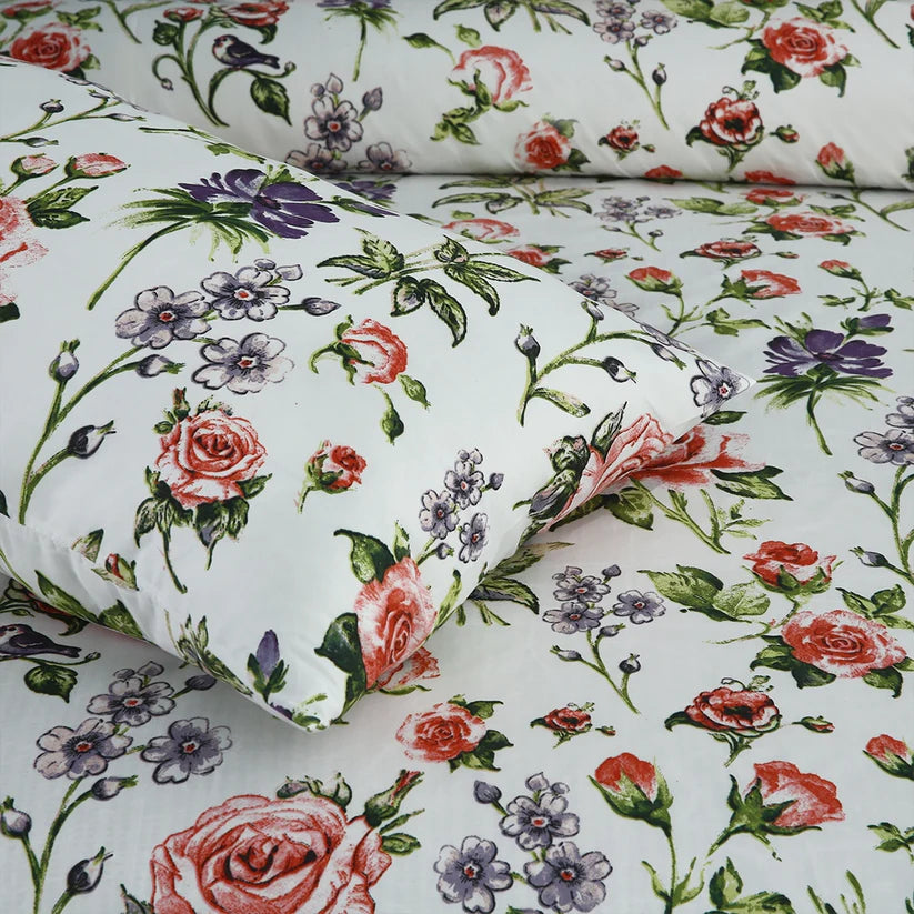 Floral patterned fabric with roses and other flowers on a white background