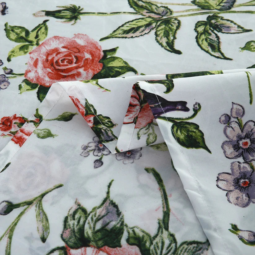 Floral patterned fabric with roses and leaves on a white background