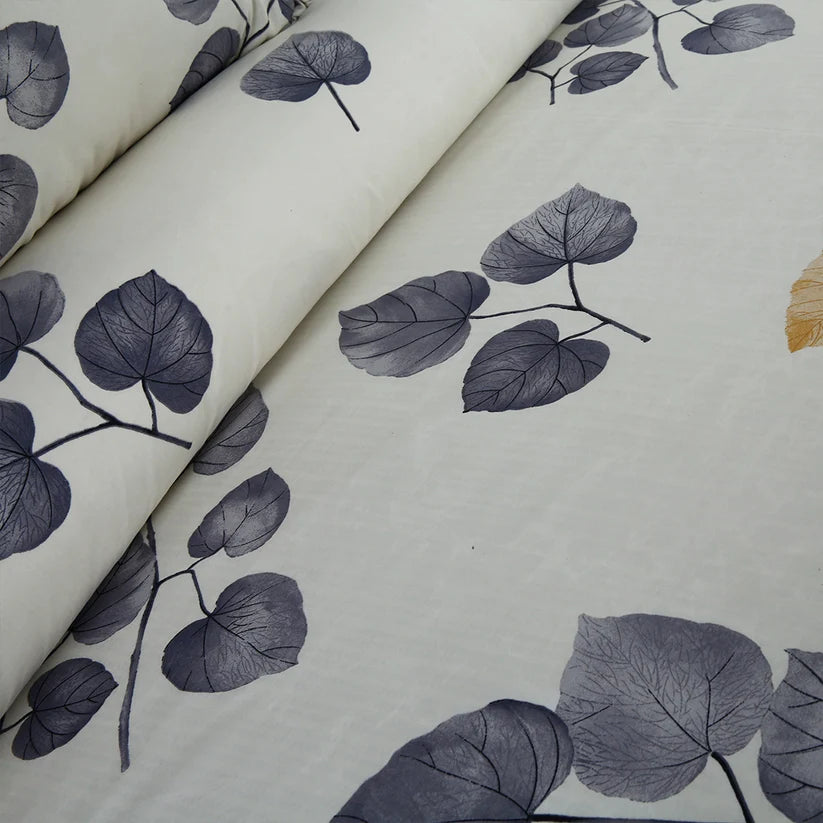 Fabric with dark blue leaf pattern on a light background