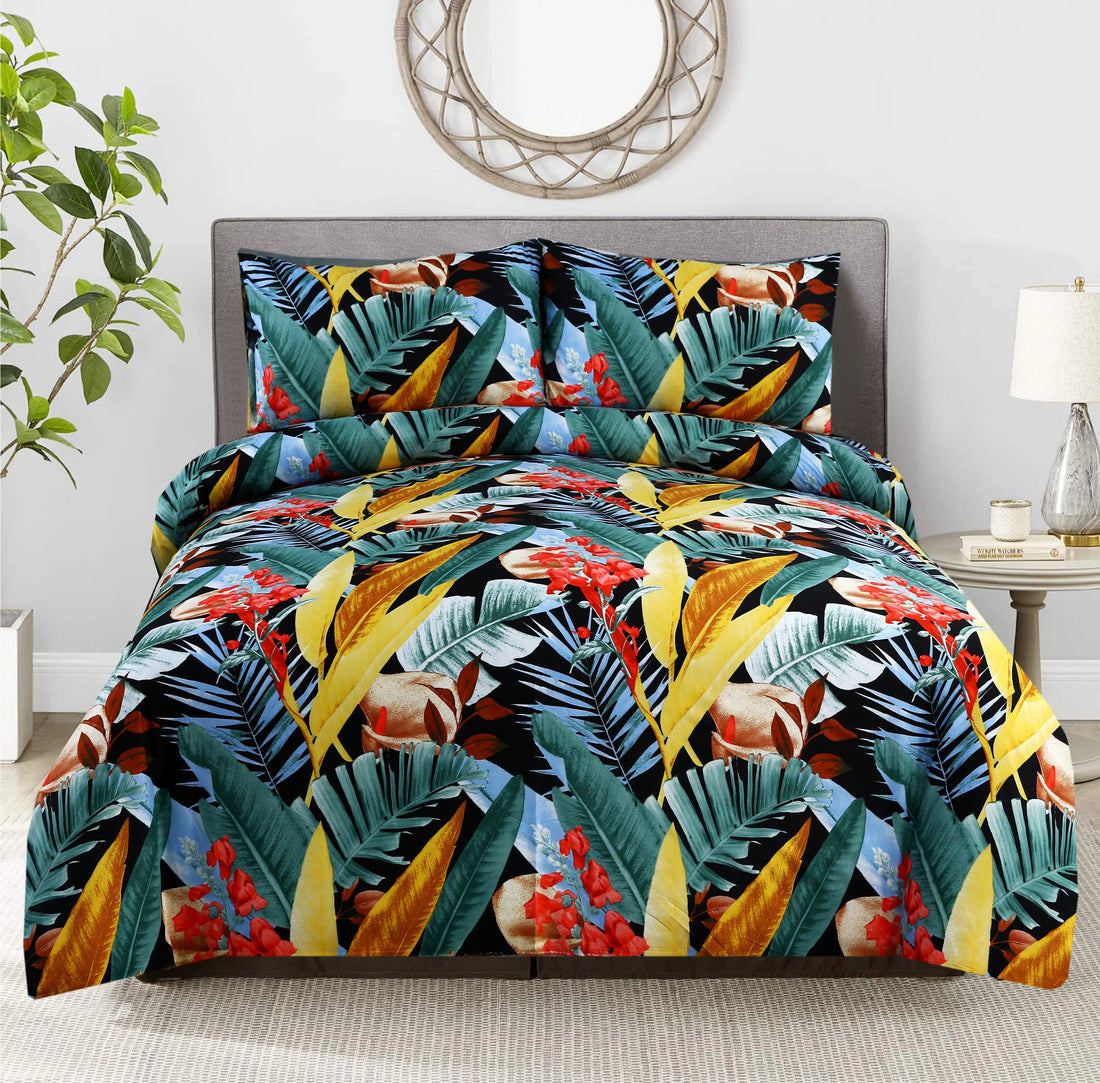 Tropical leaf patterned comforter set on a bed in a room with a plant and lamp.