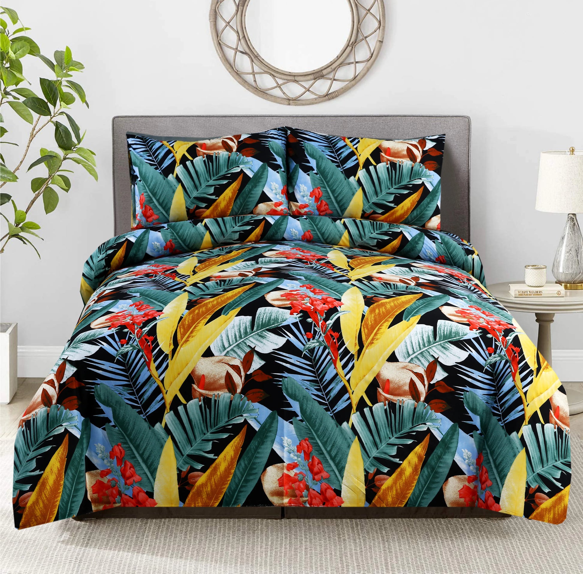 Tropical leaf patterned comforter set on a bed in a room with a plant and lamp.