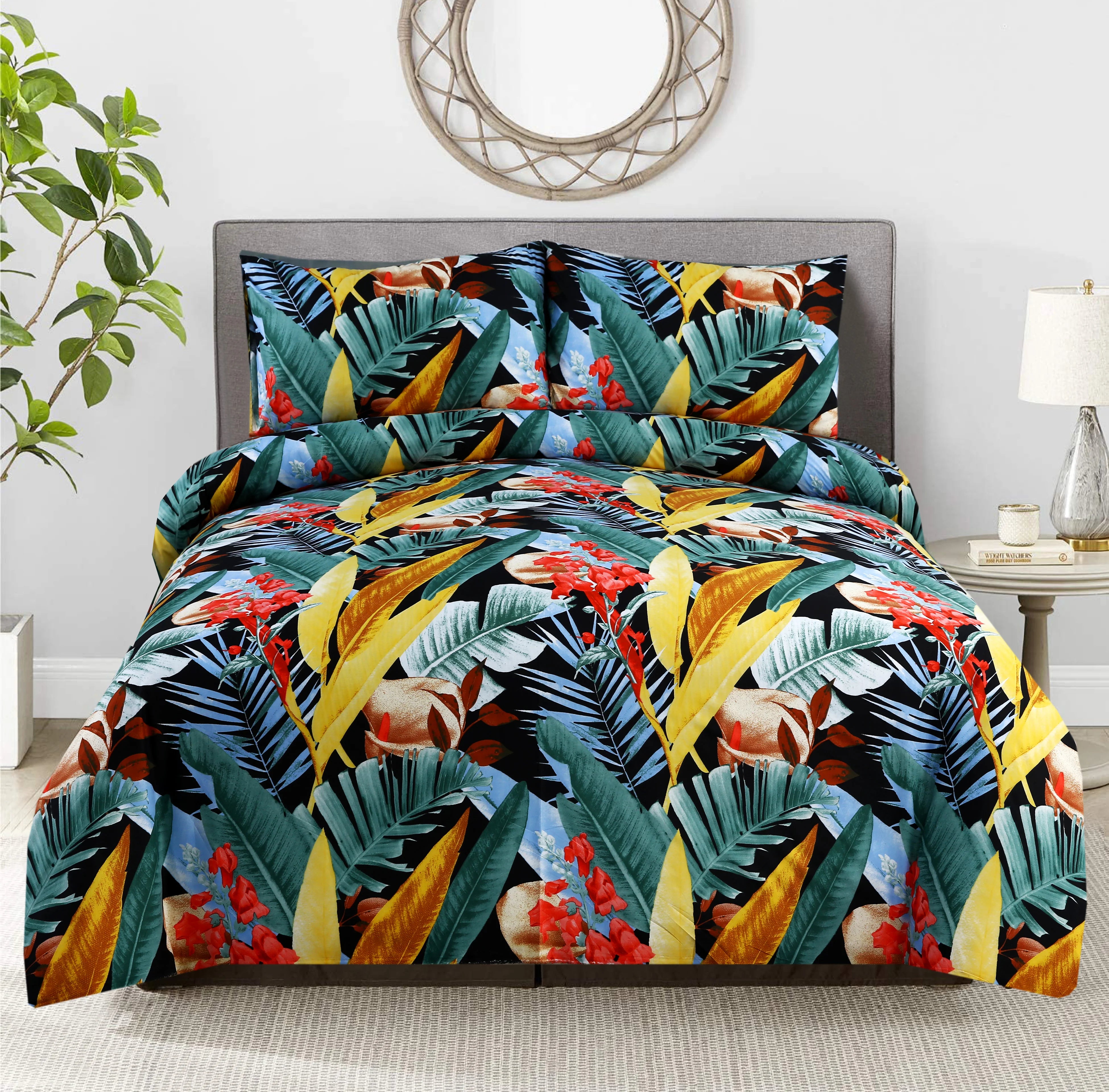 Tropical leaf patterned comforter set on a bed in a room with a plant and lamp.