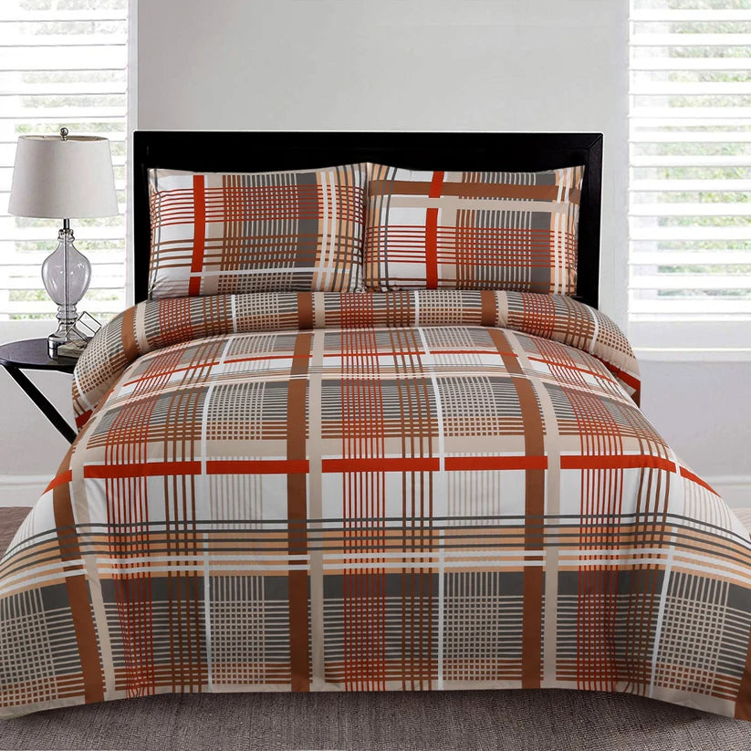Plaid patterned bedspread on a bed with matching pillows in a bedroom setting.