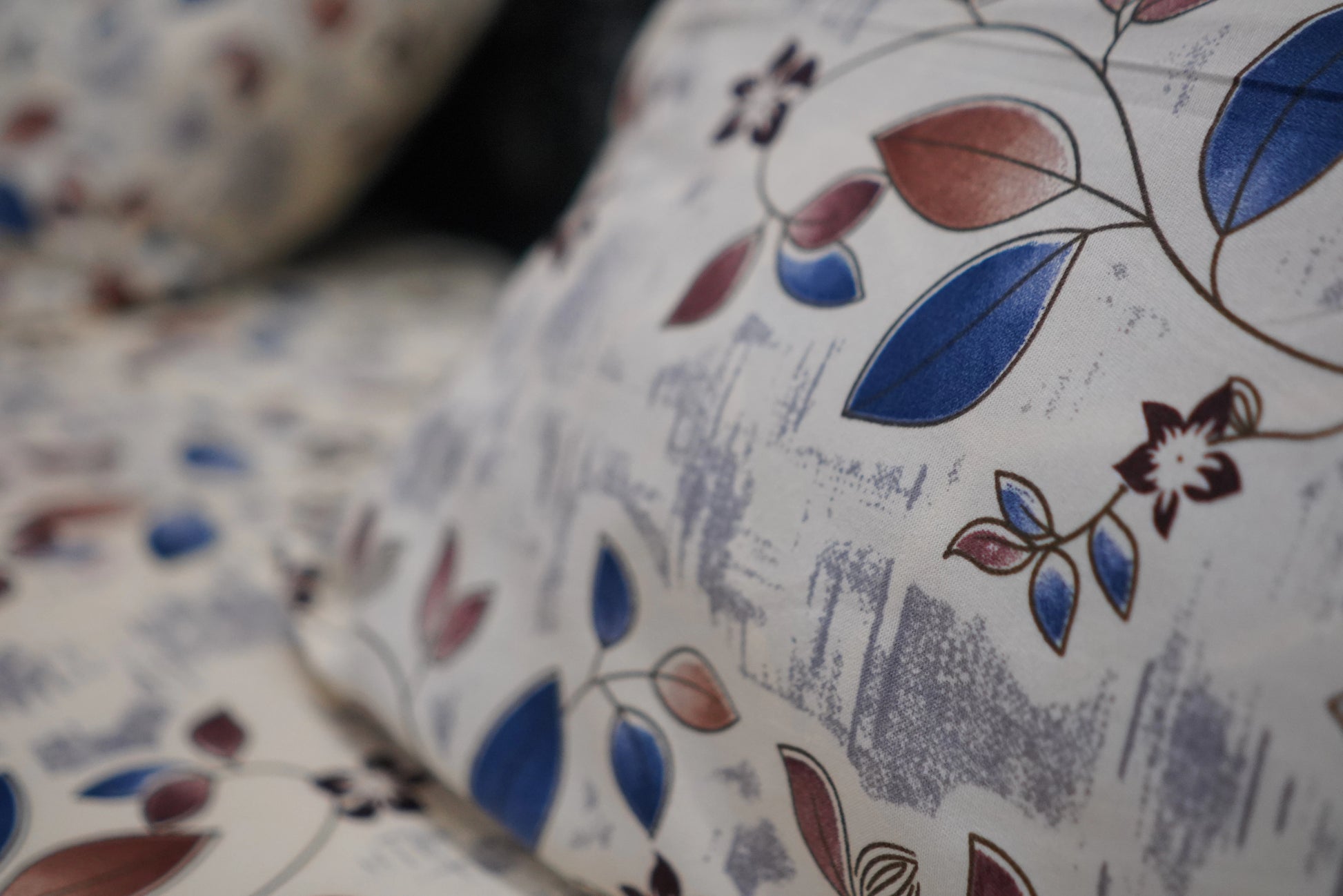 Close-up of fabric with floral pattern on a white background