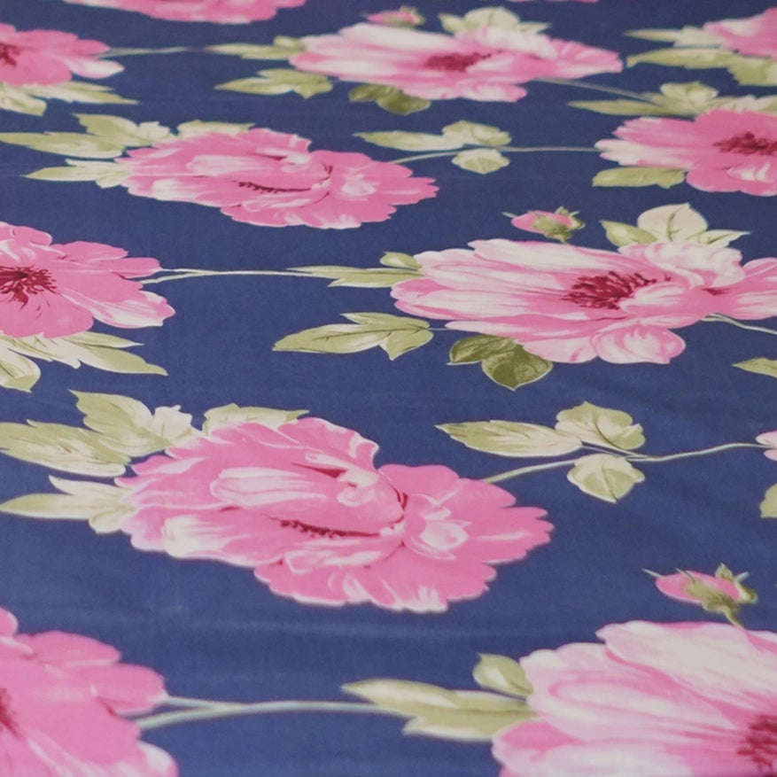 Floral bedding set on a bed with a white wall background