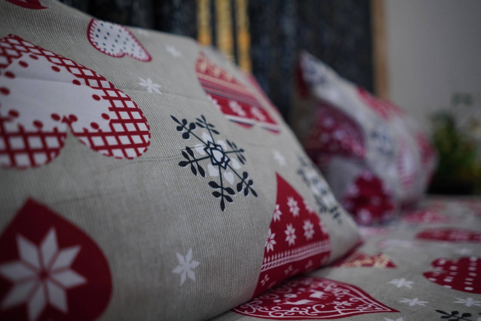 Decorative pillows with red and white patterns on a blurred background