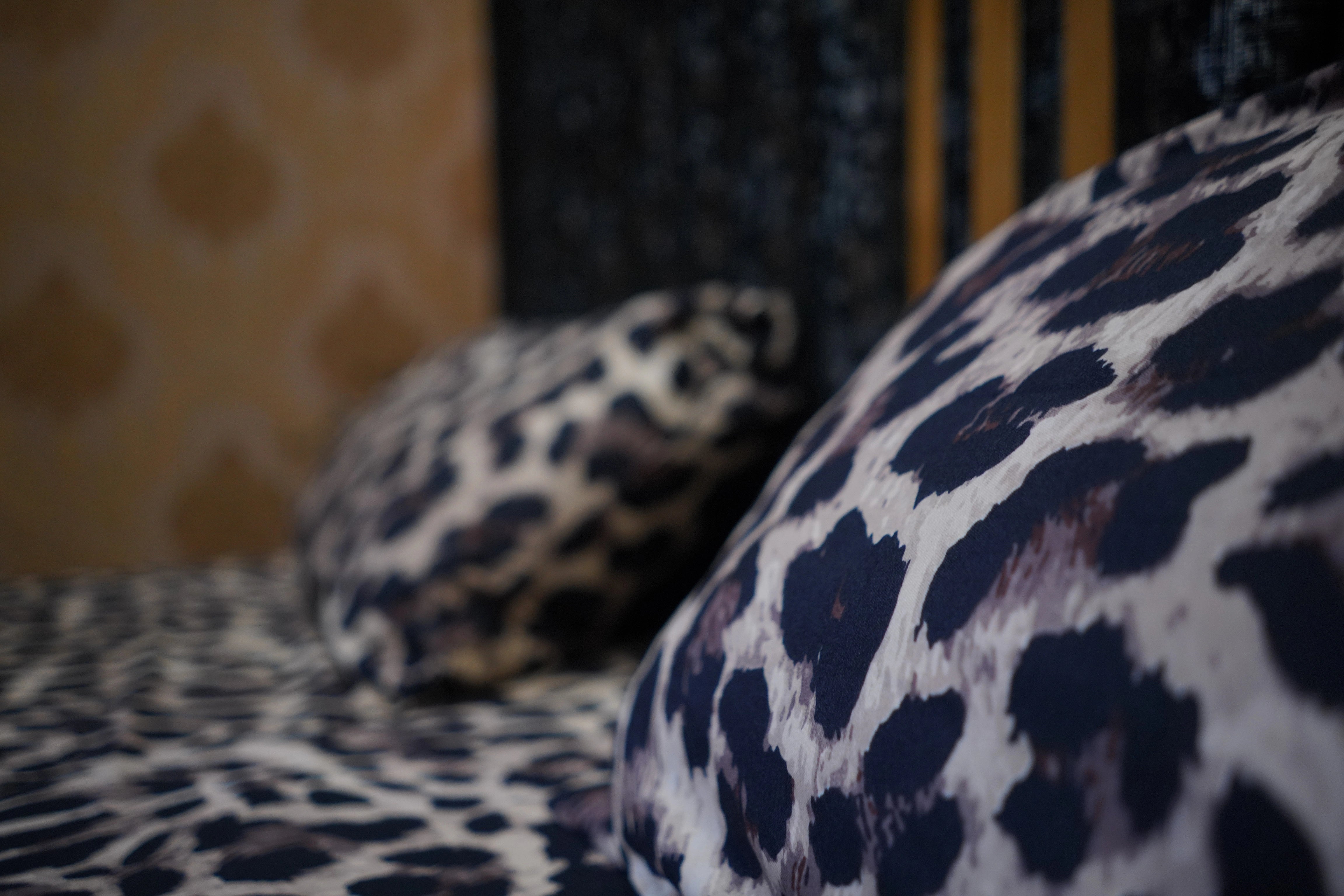 Leopard print cushions on a bed with a blurred background