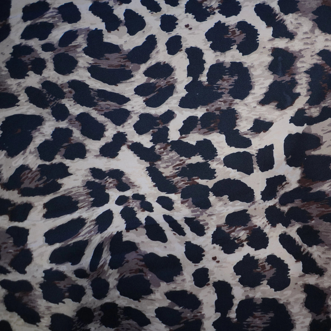 Leopard print bedding set on a bed in a bedroom setting.
