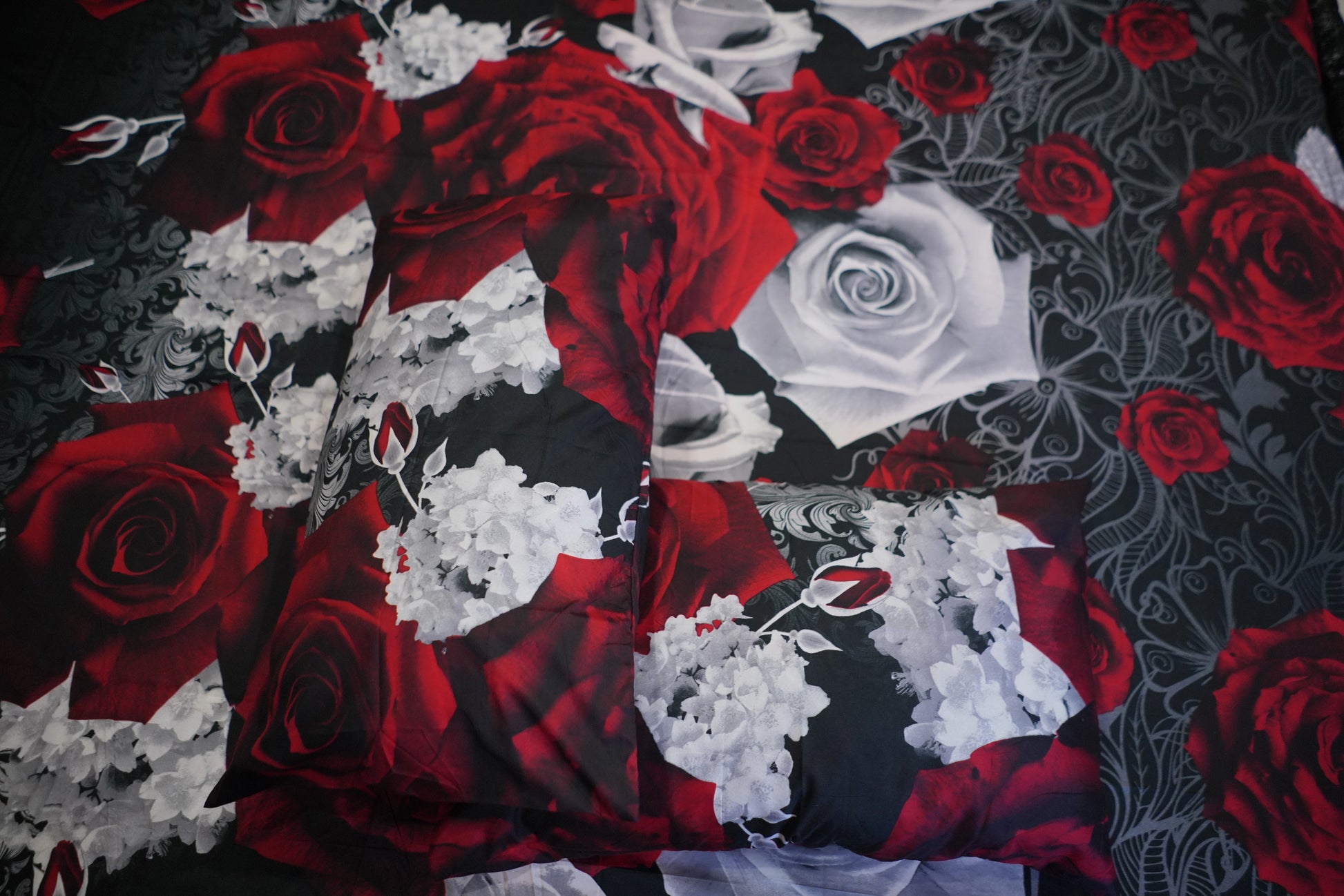Fabric with red and white roses on a black background