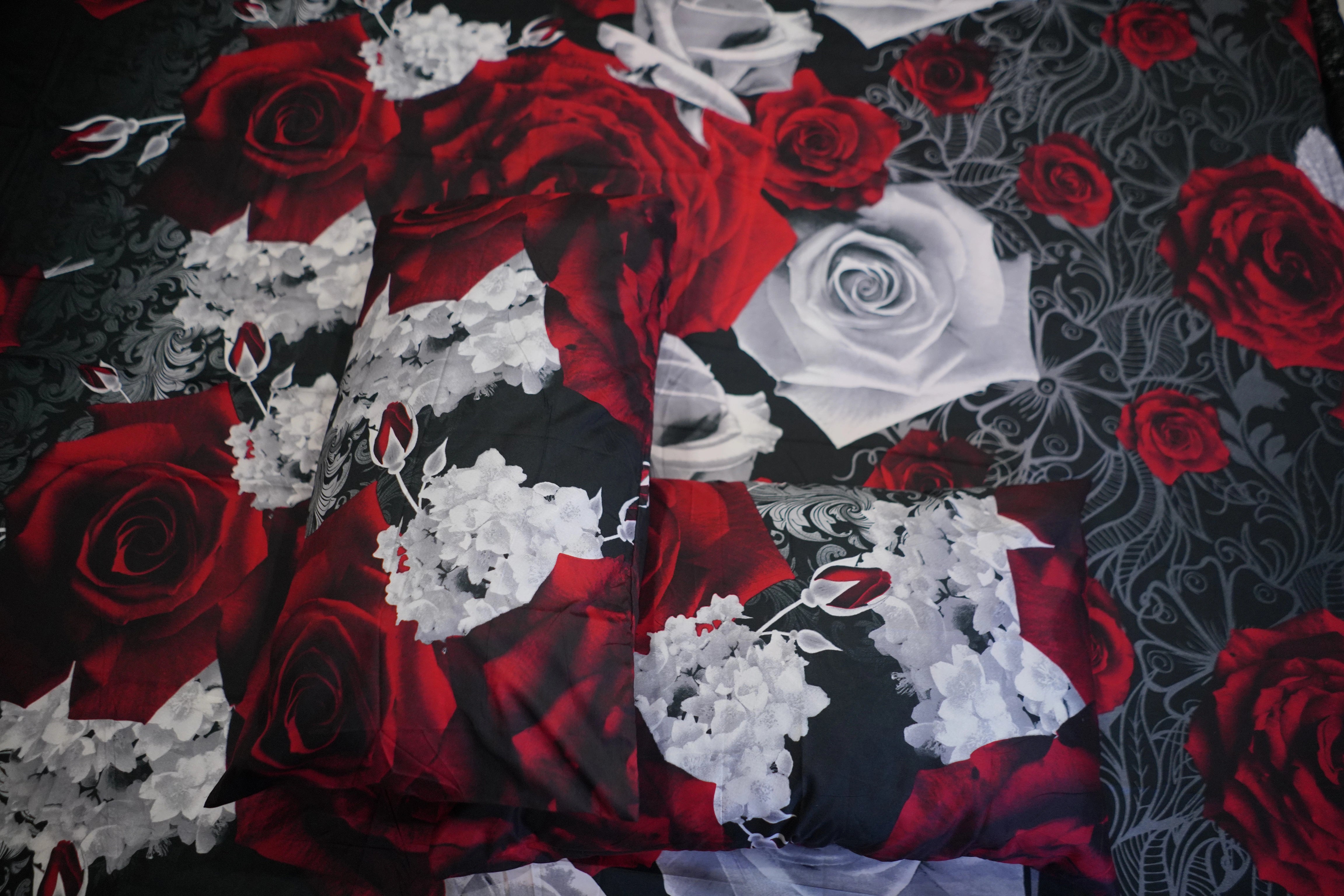 Fabric with red and white roses on a black background