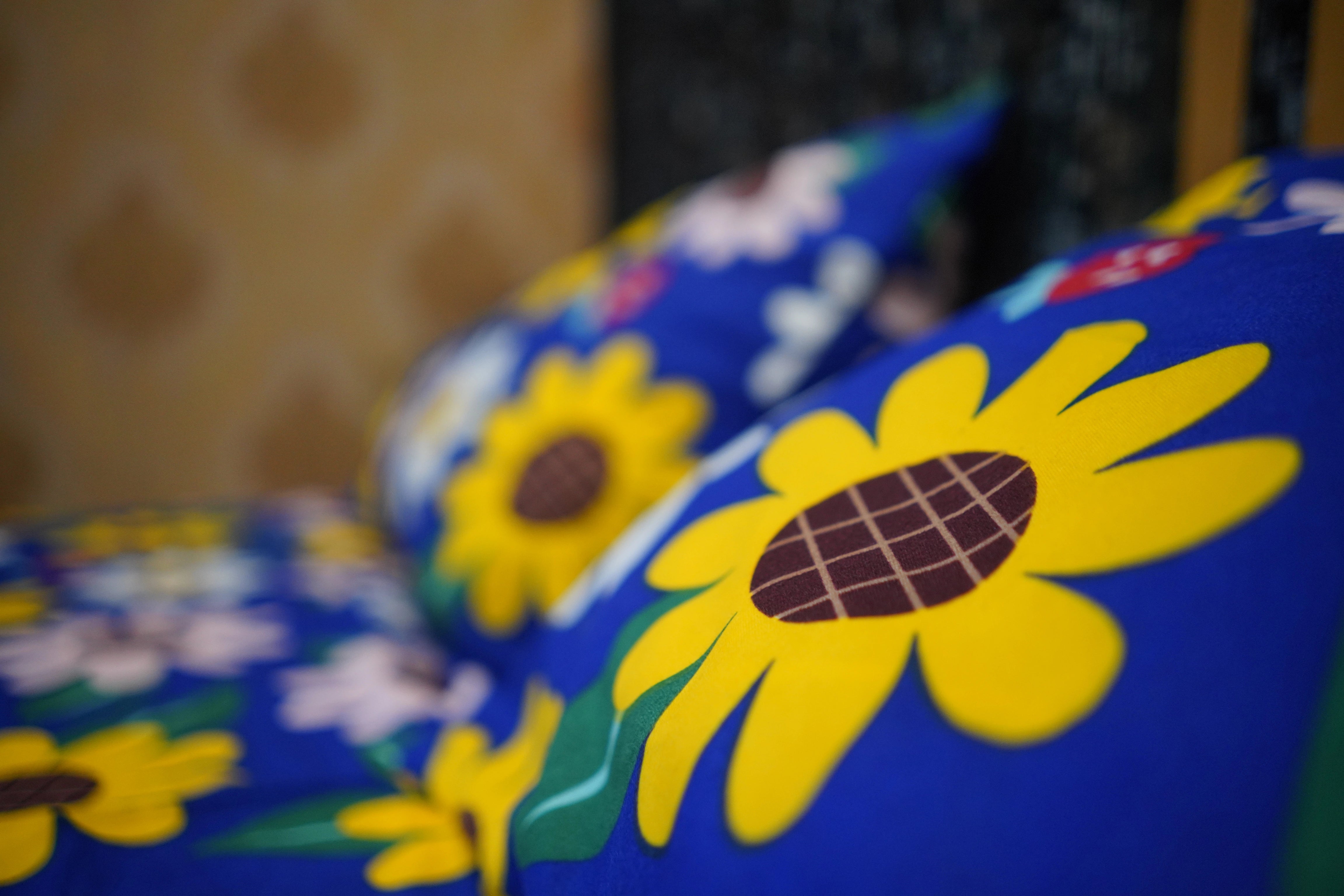 Close-up of a blue box with yellow sunflower designs on a blurred background