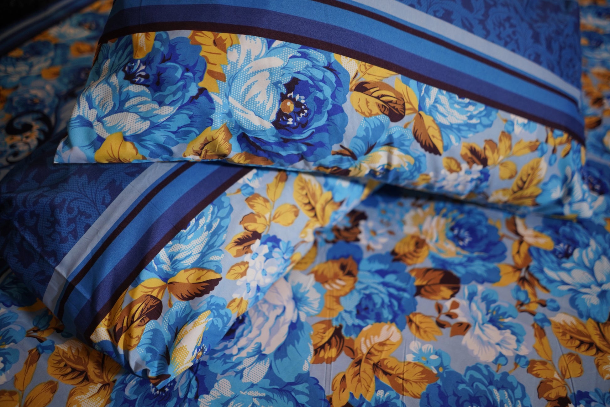 Floral patterned fabric with blue and yellow flowers on a blue background
