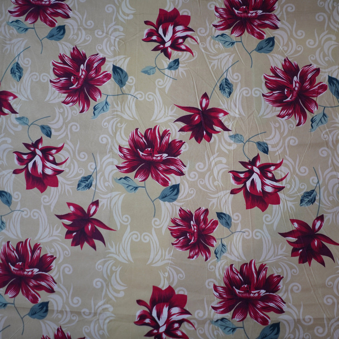 Floral bedding set on a bed with a window and decor in the background
