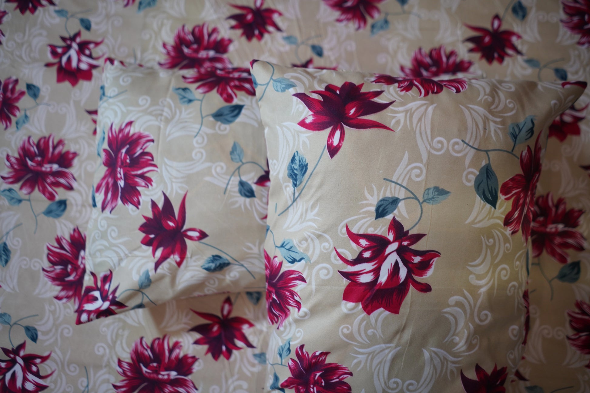 Floral-patterned pillows on a matching fabric background
