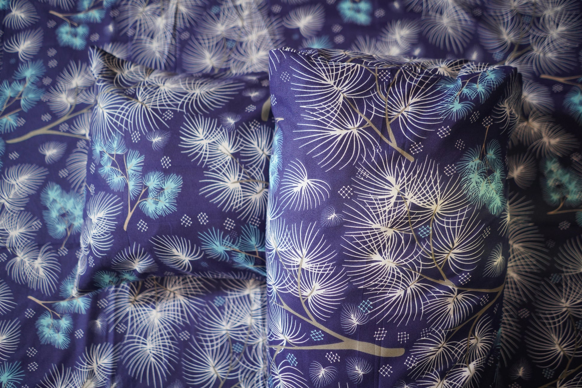 Floral patterned fabric with blue and white colors on a dark background