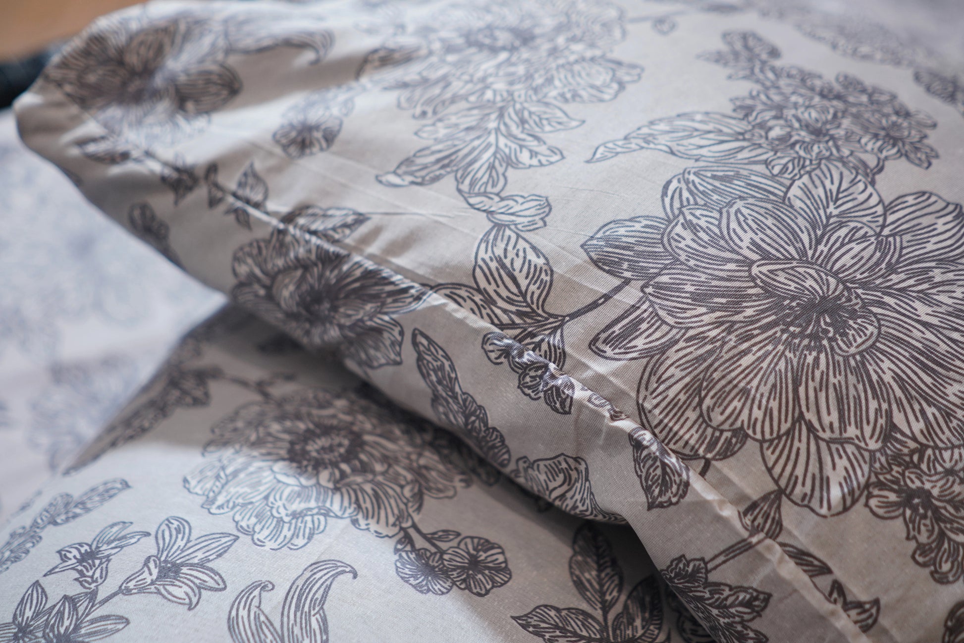 Floral patterned fabric with black outlines on a light background