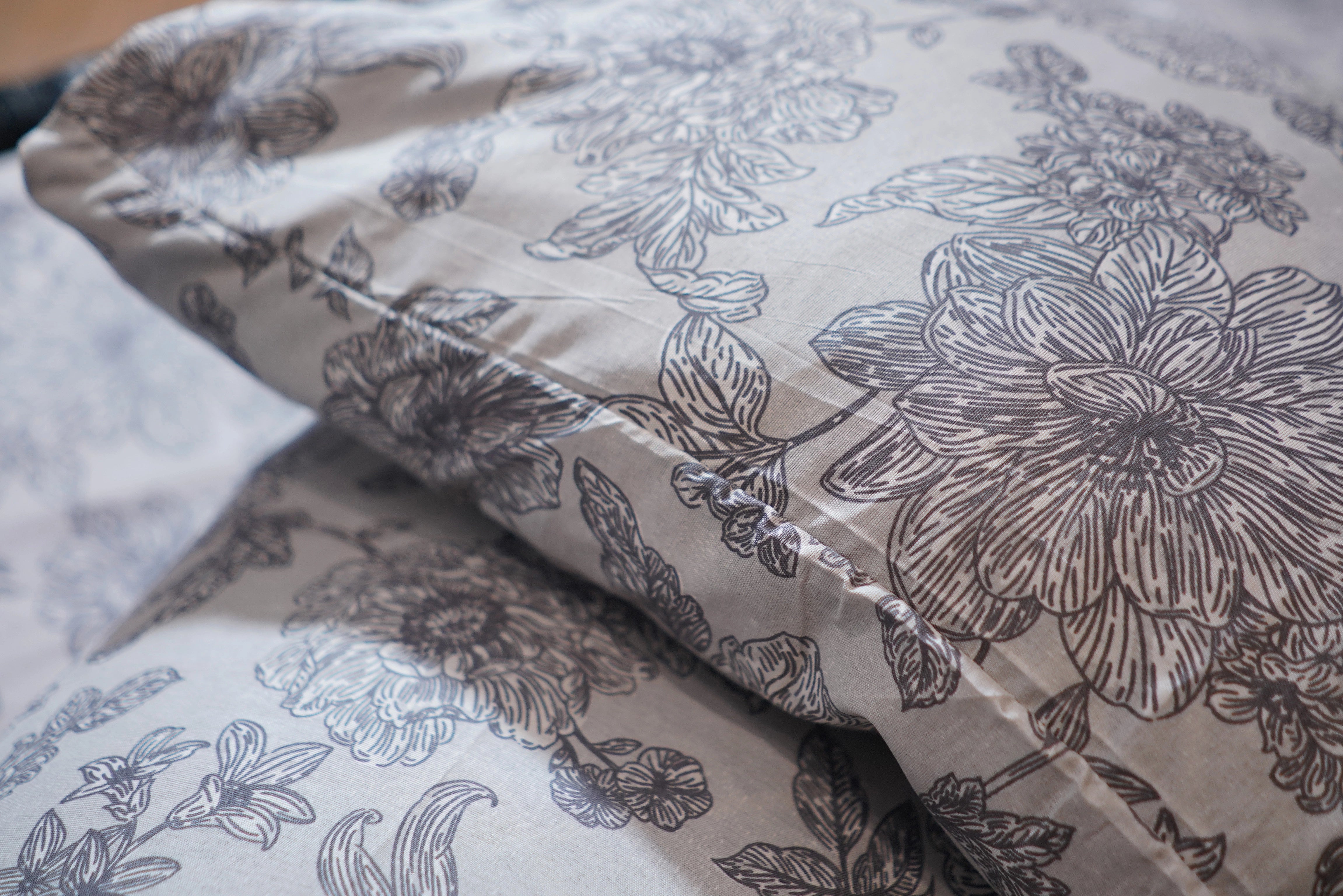 Floral patterned fabric with black outlines on a light background