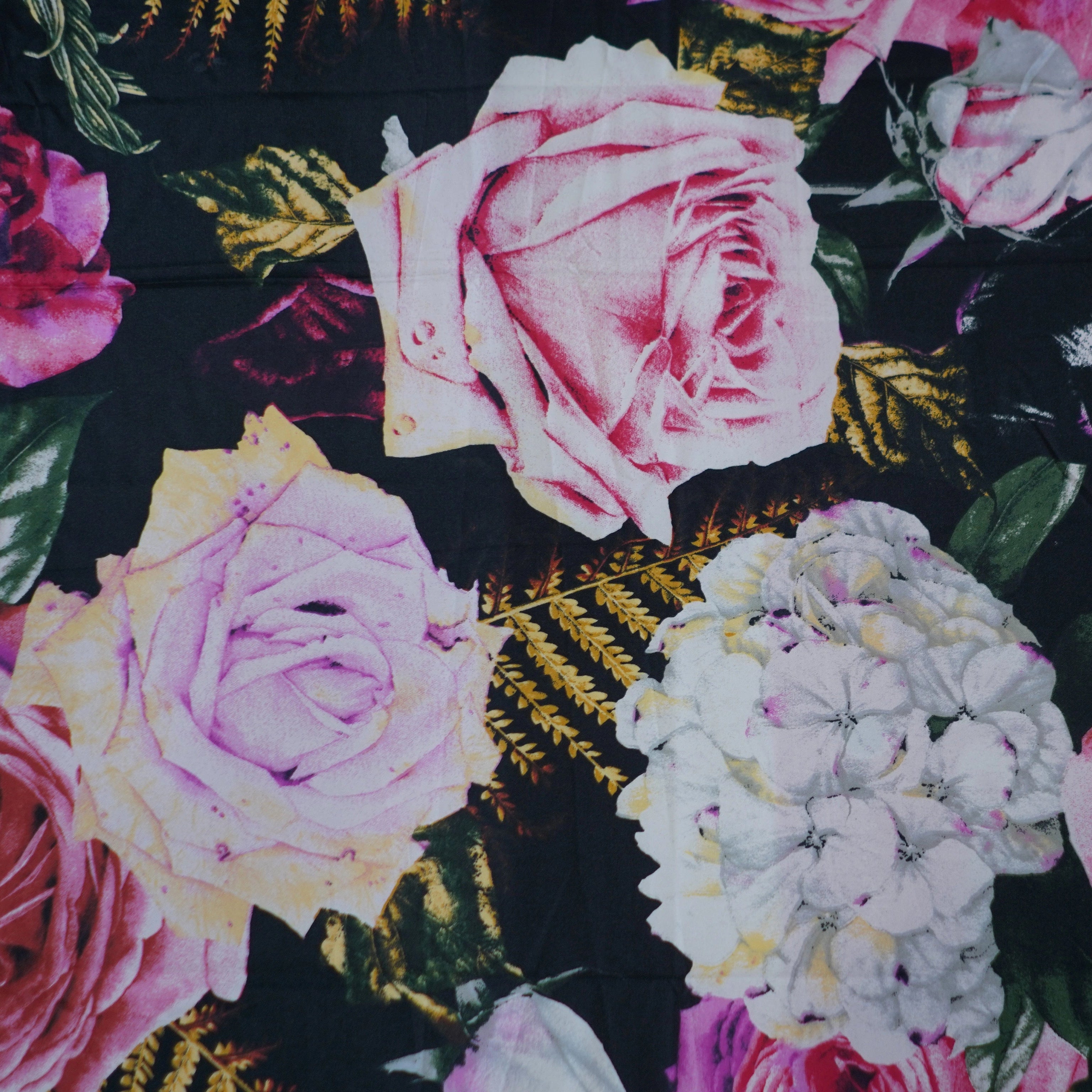 Floral pattern with pink, white, and purple flowers on a black background