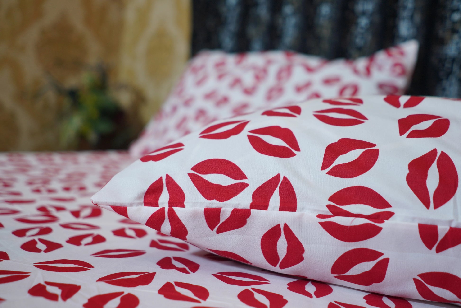Red lip print on white fabric with a blurred background