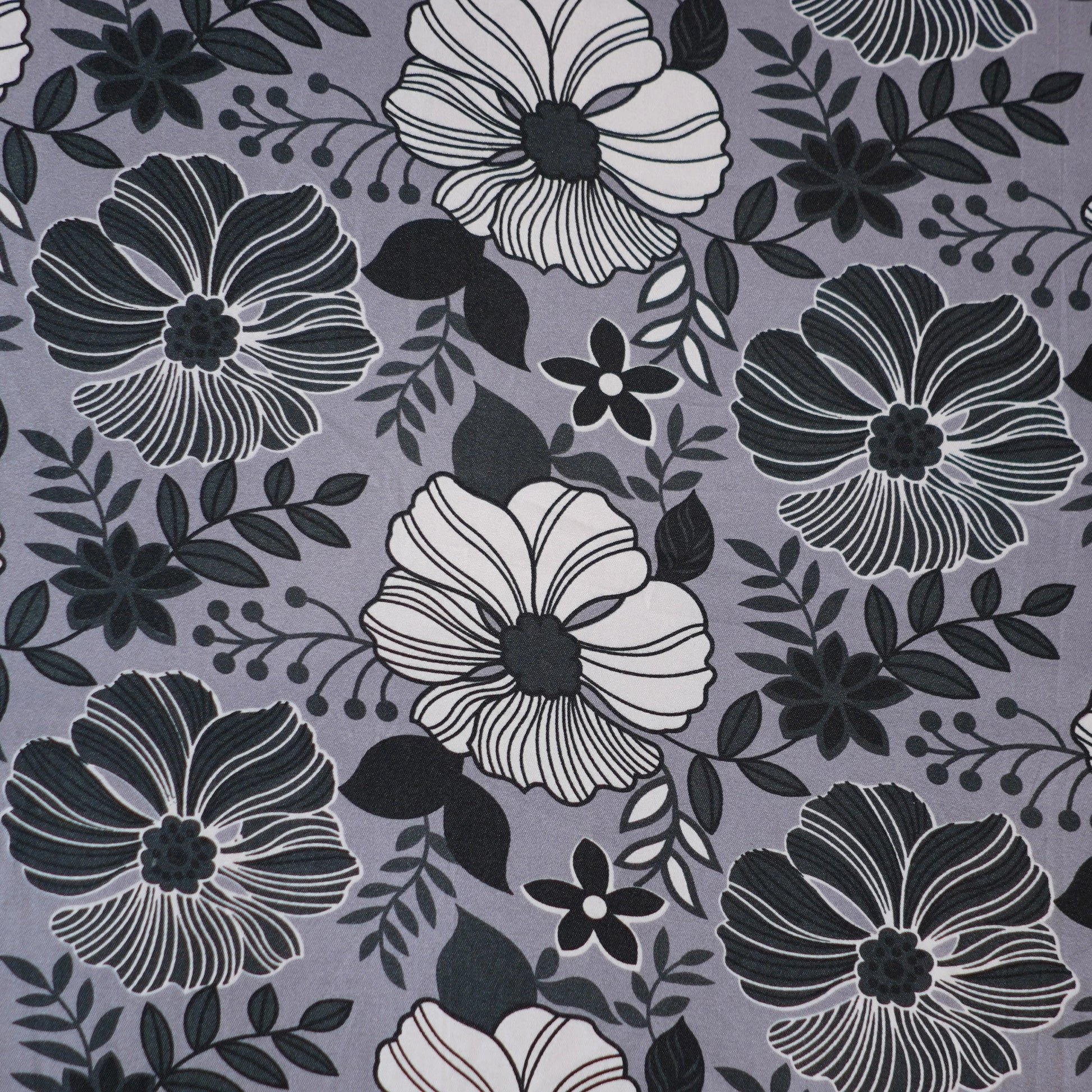 Floral pattern with black and white flowers on a gray background