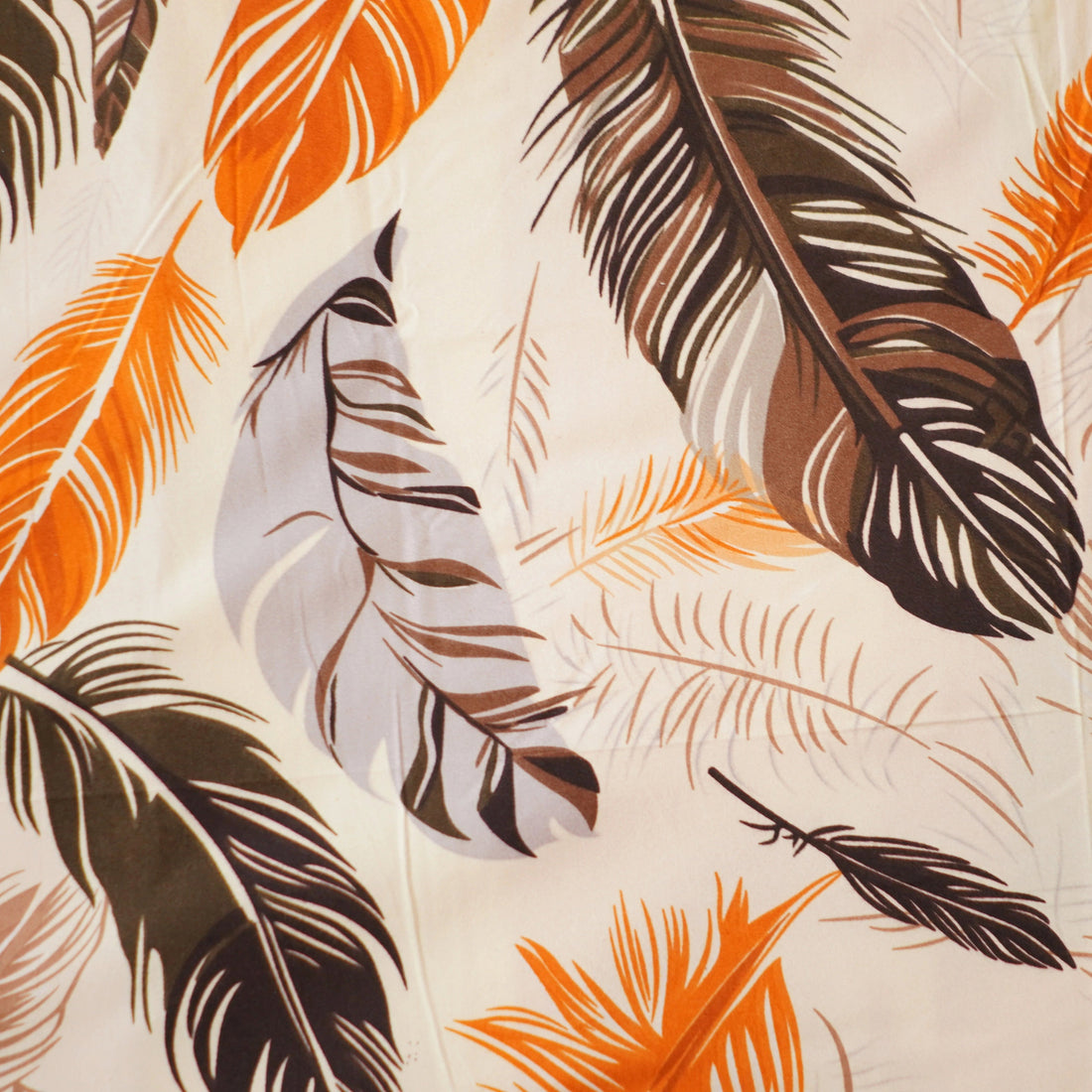 Bedding set with feather pattern in a bedroom setting