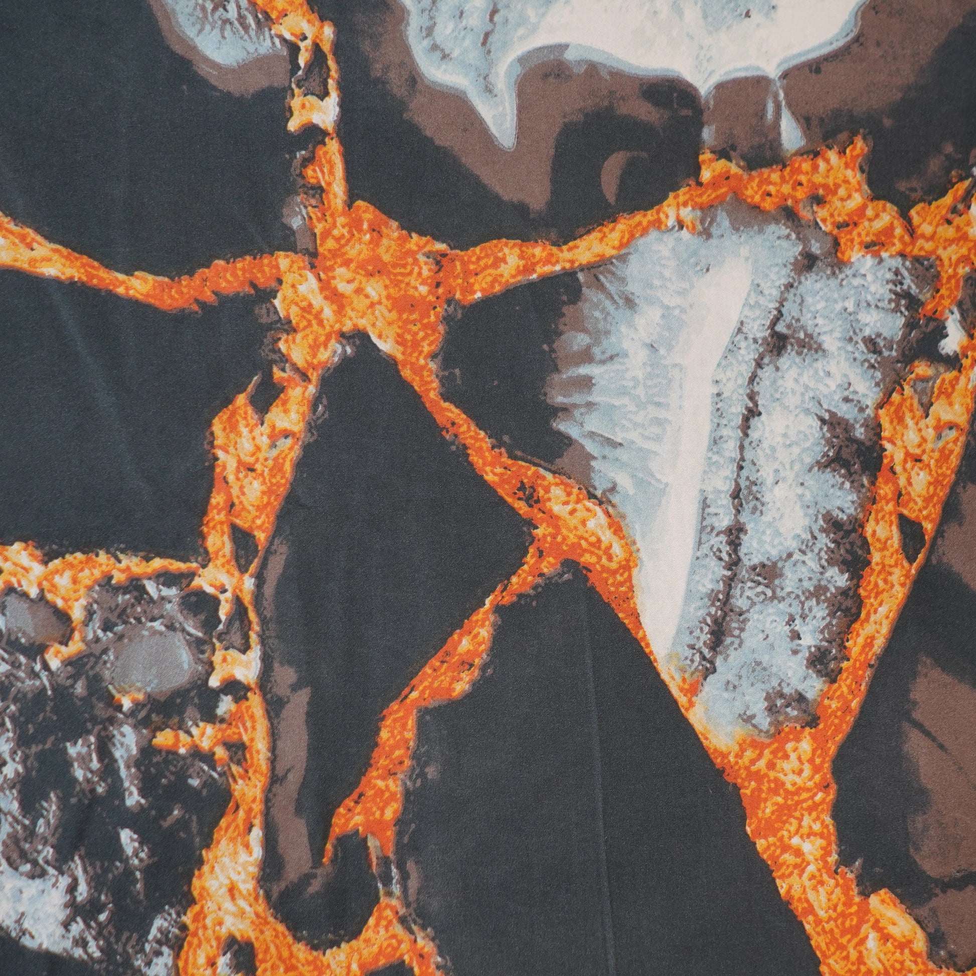 Close-up of a textured surface with orange, brown, and gray patterns