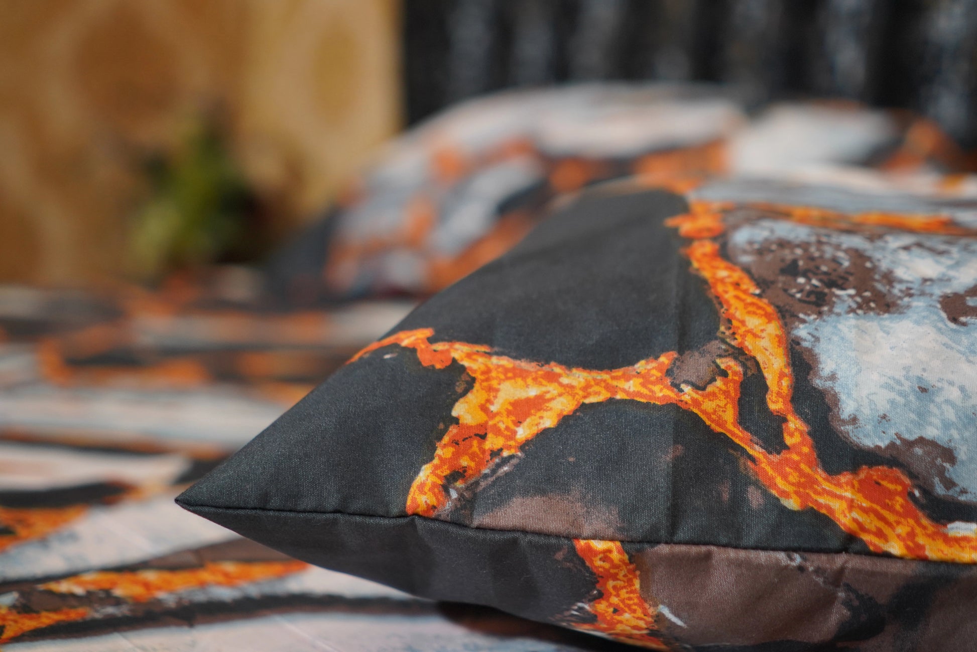 Decorative pillow with lava design on a bedspread
