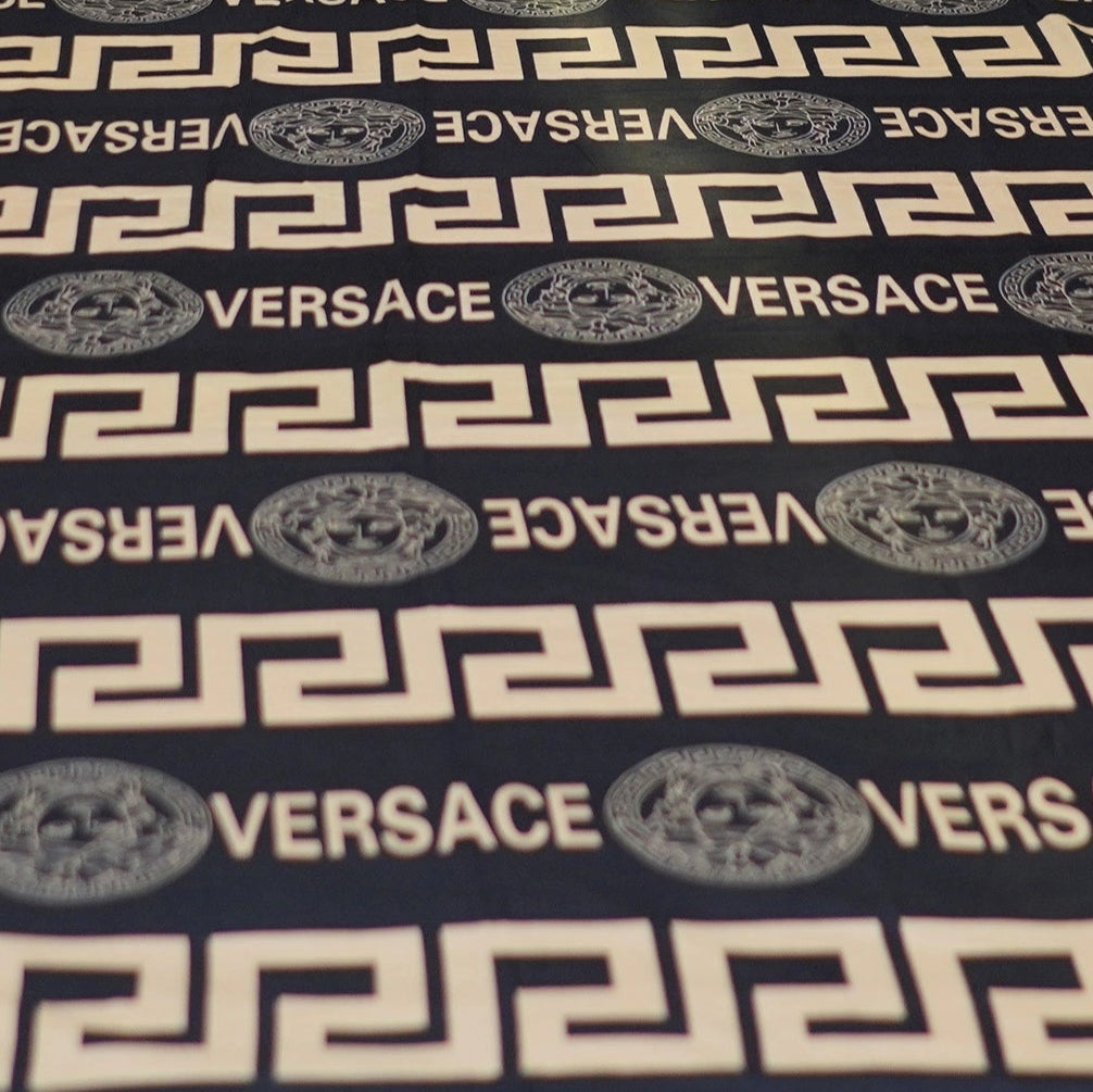 Versace bedspread set on a bed in a bedroom setting
