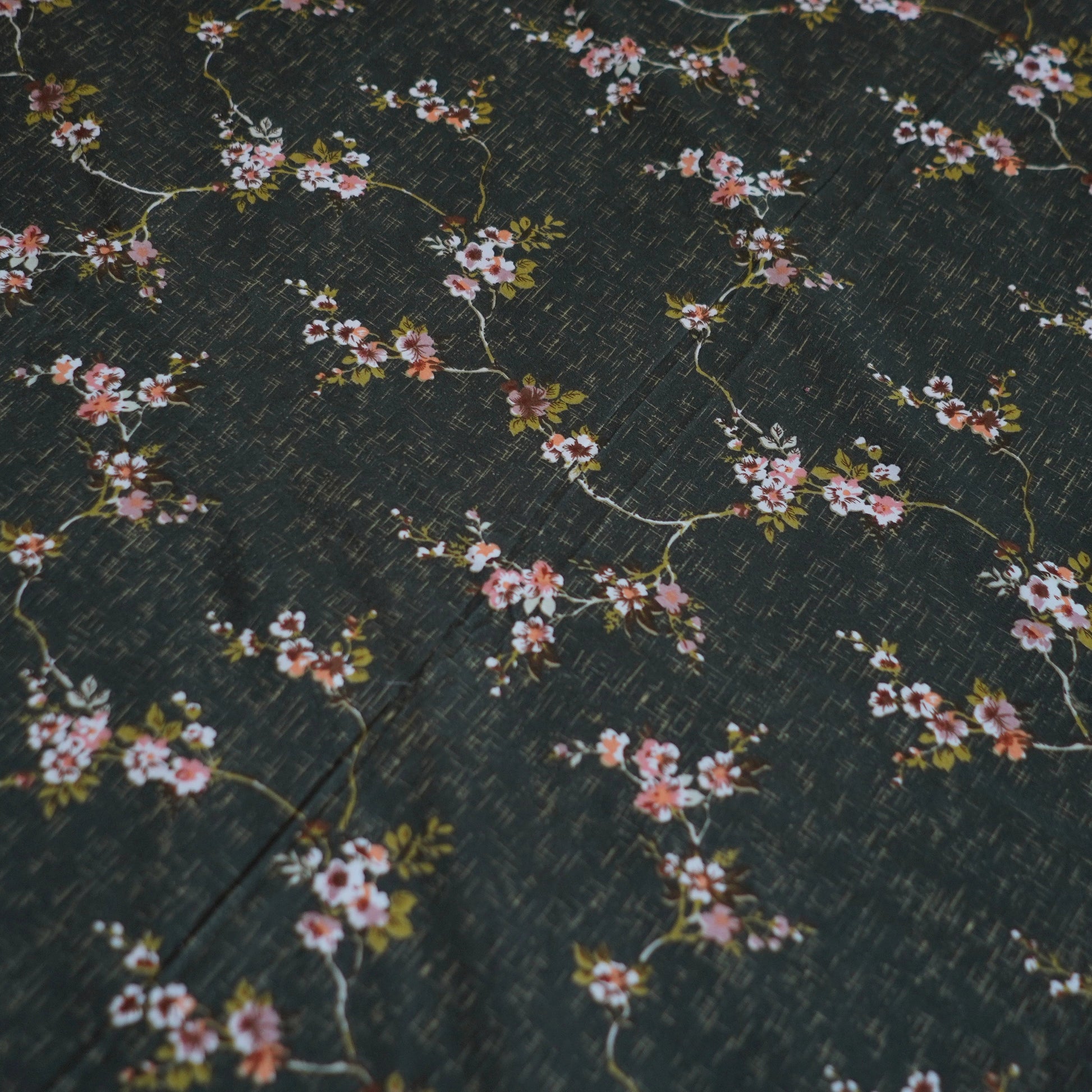Floral pattern on a dark fabric background