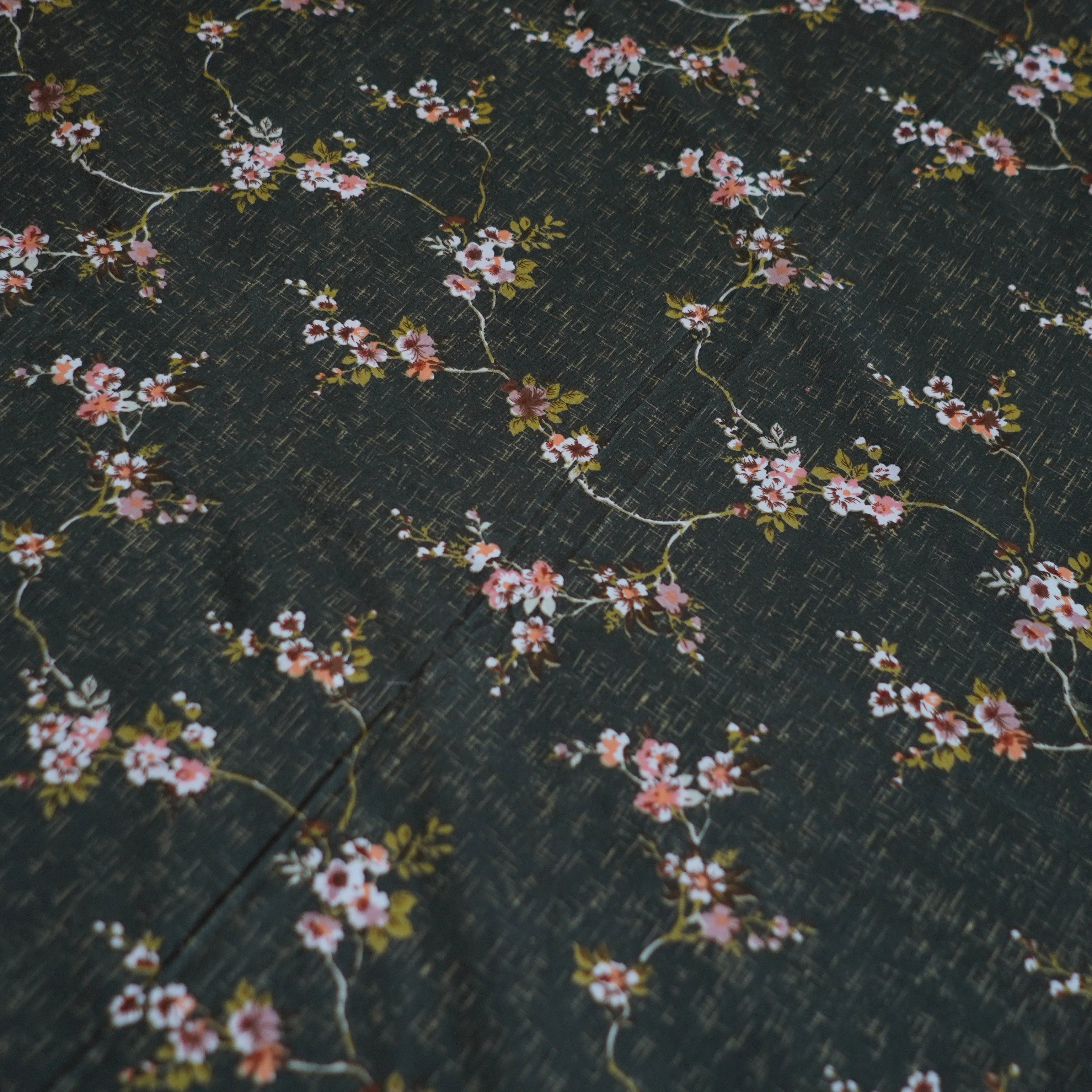Floral pattern on a dark fabric background