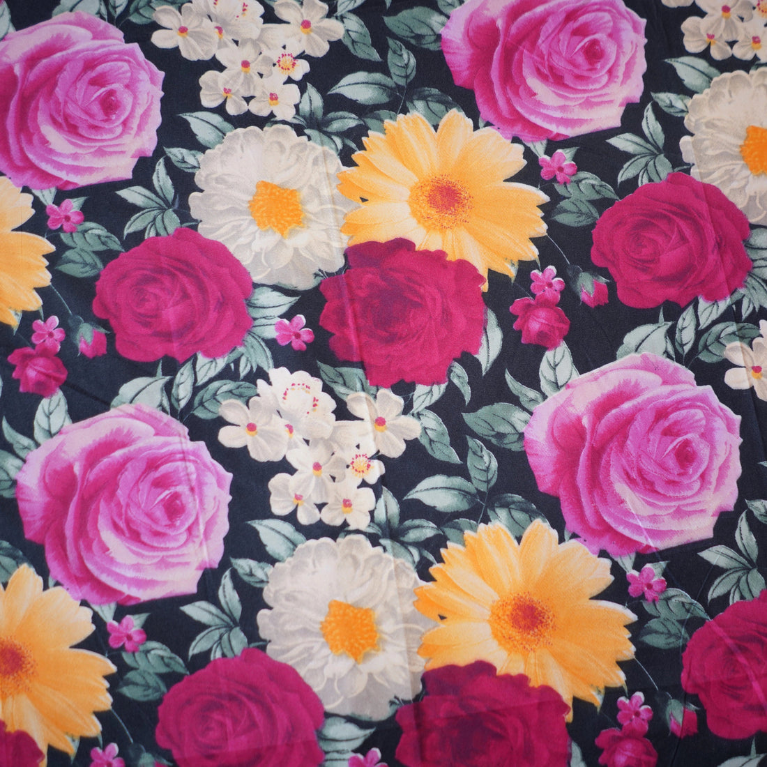 Floral patterned comforter set on a bed in a bedroom setting.