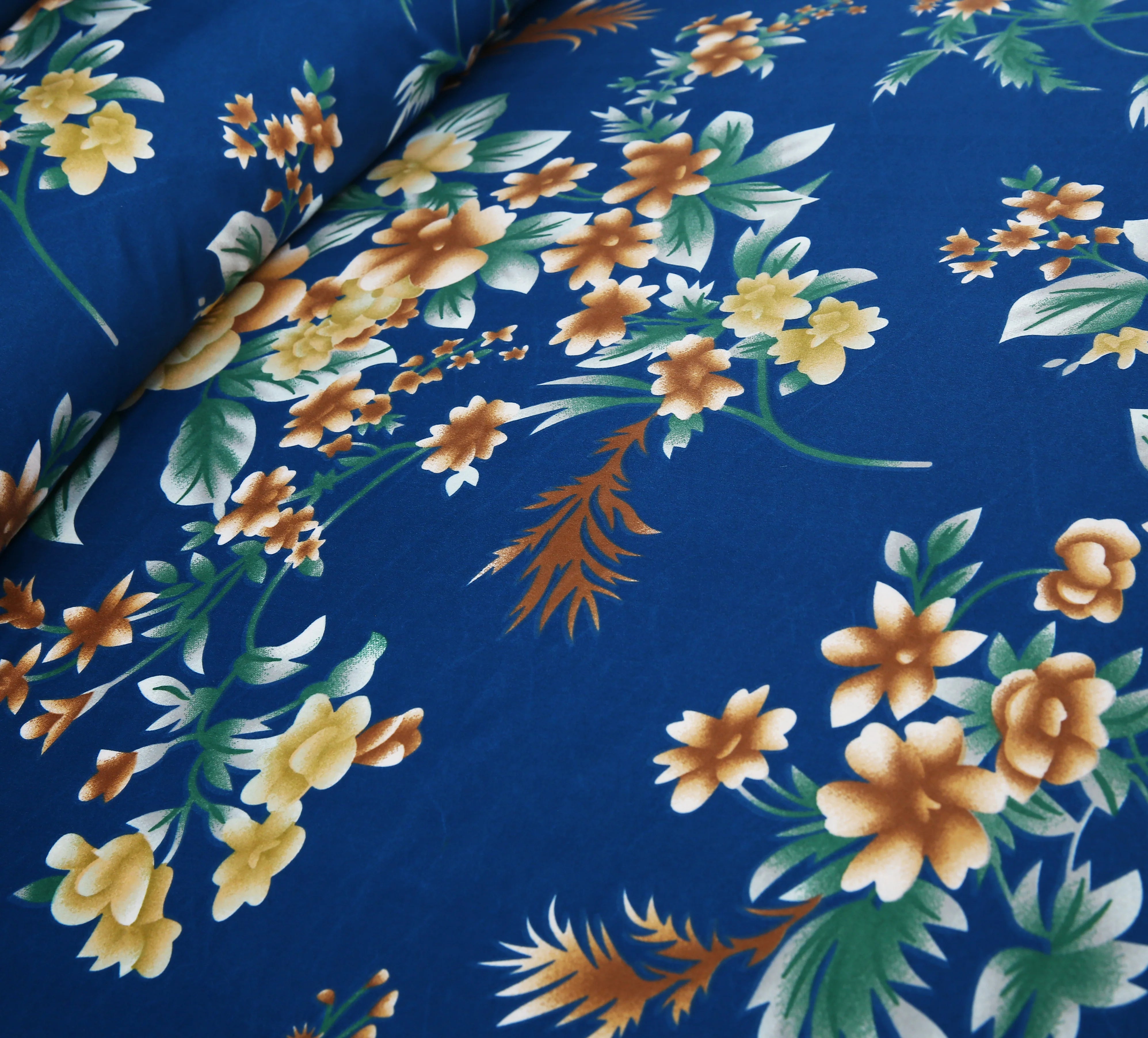 Floral fabric pattern with yellow and orange flowers on a blue background