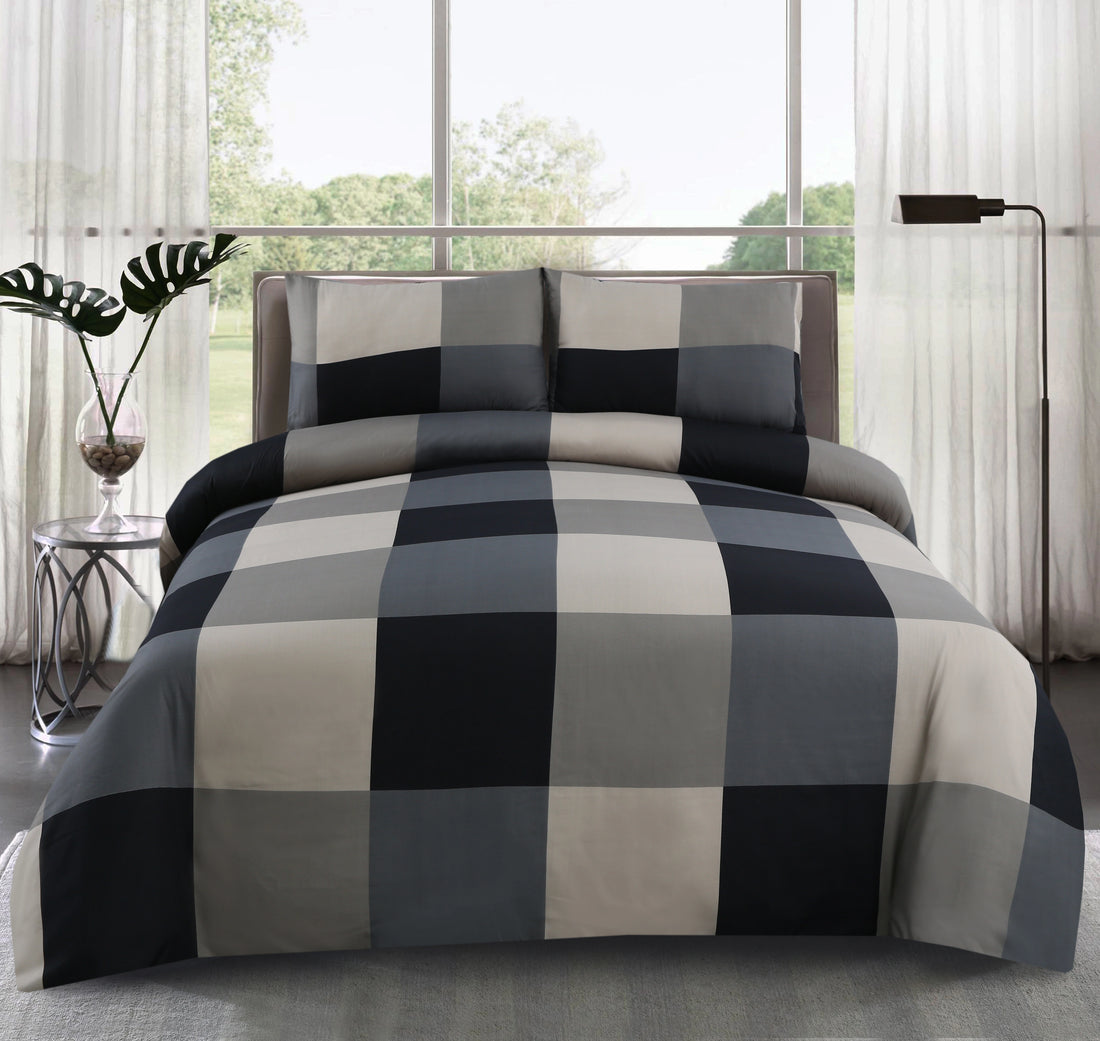 Checkered bedspread on a bed in a bright room with large windows.