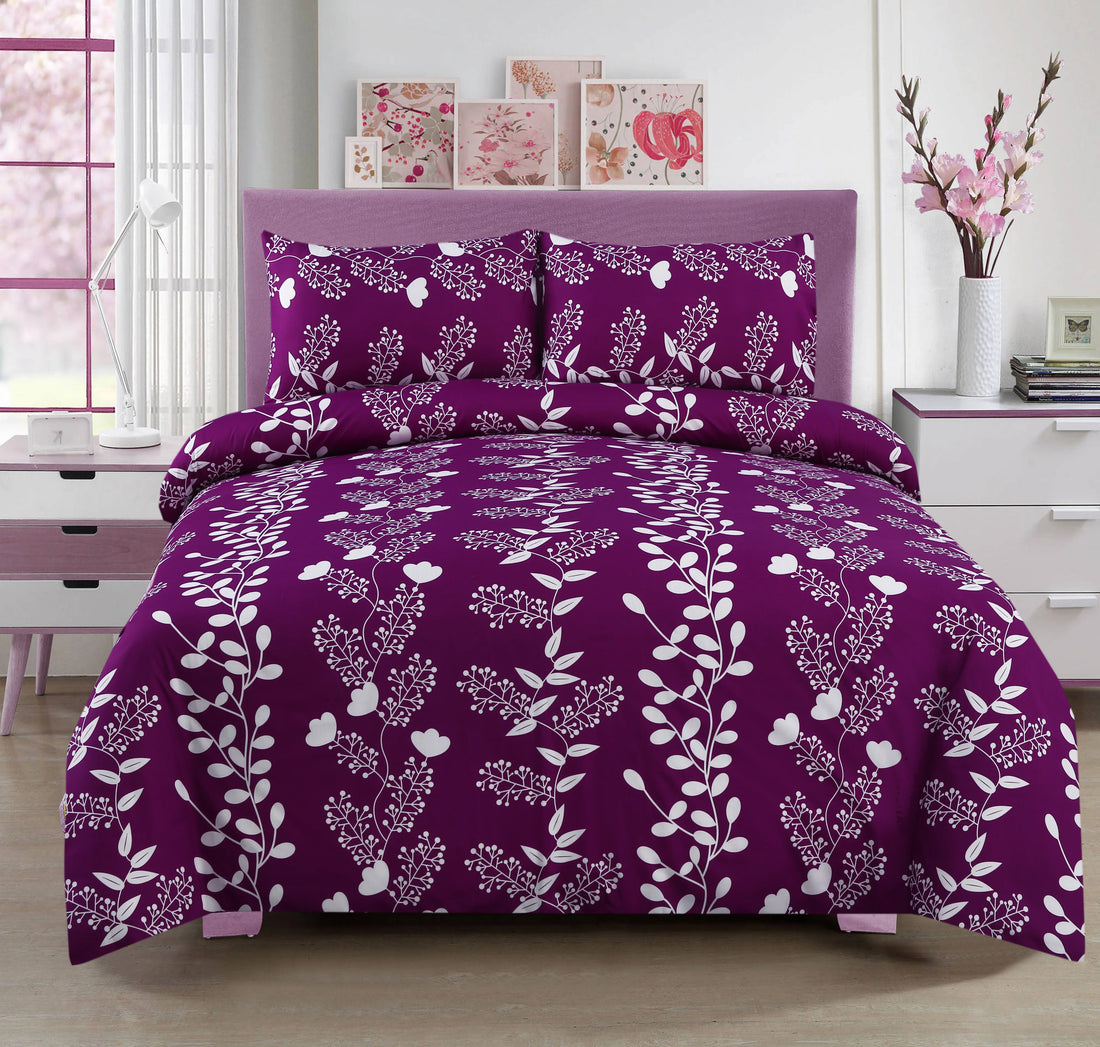 Purple floral bedding set on a bed in a bedroom with pink decor.