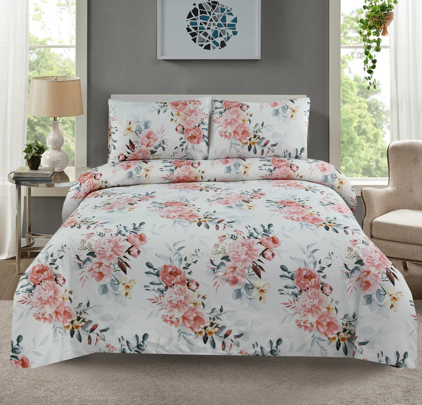 Floral bedding set on a bed in a room with a lamp and window.