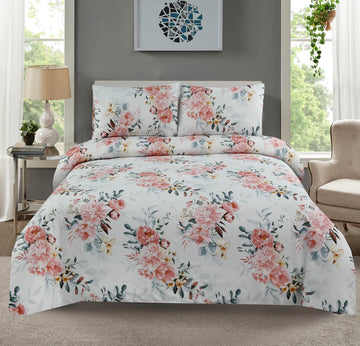 Floral bedding set on a bed in a room with a lamp and window.