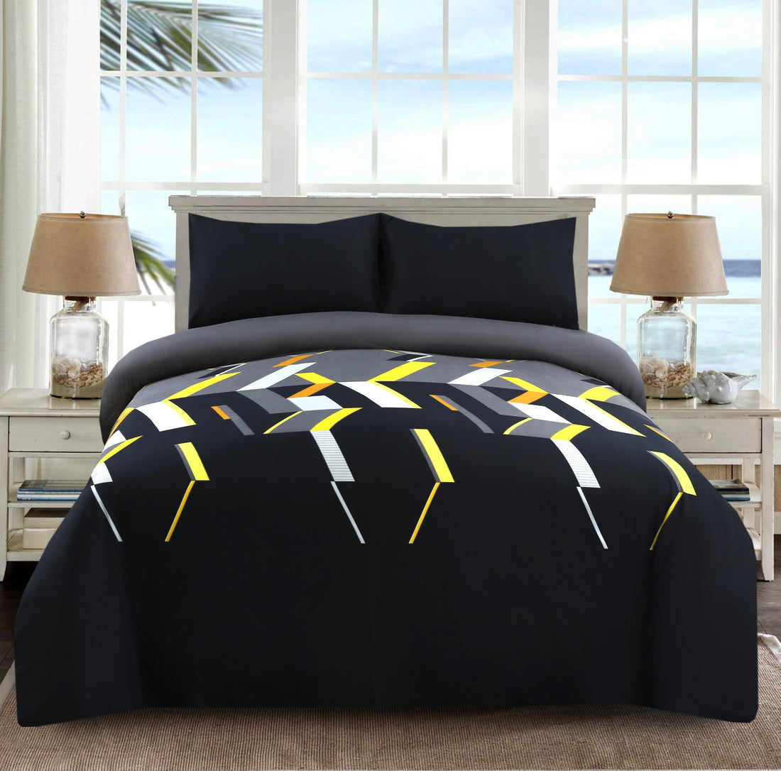 Bed with geometric patterned comforter in a room with large windows.