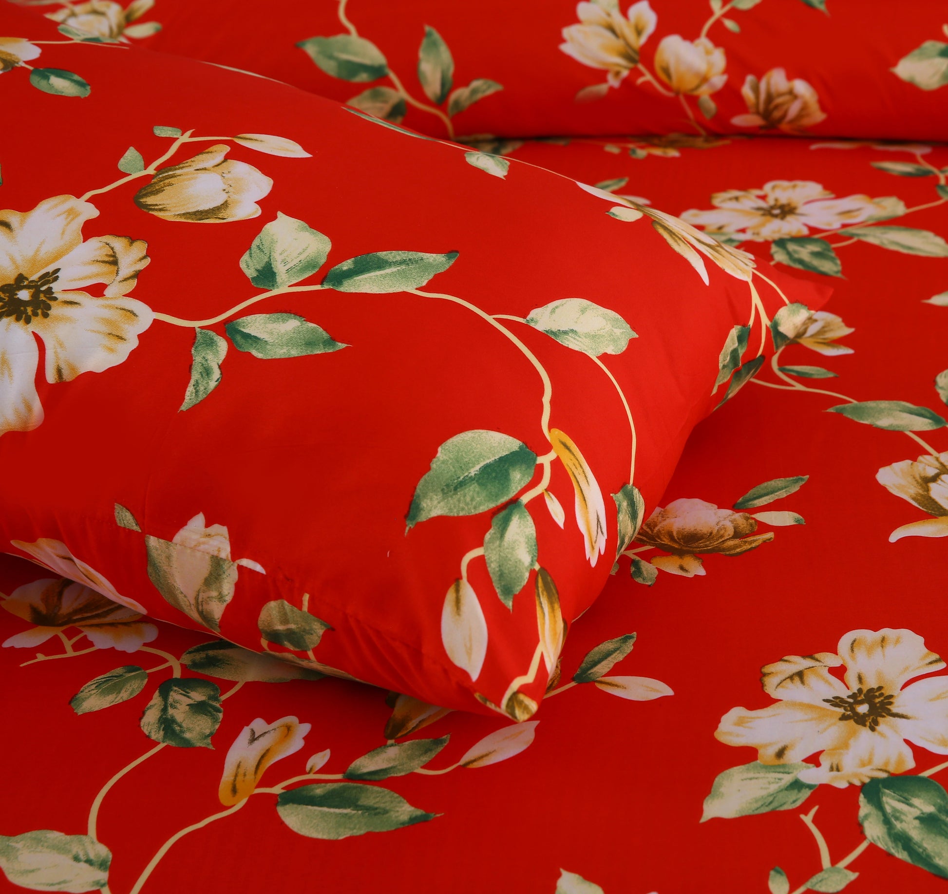 Red fabric with white floral and green leaf pattern